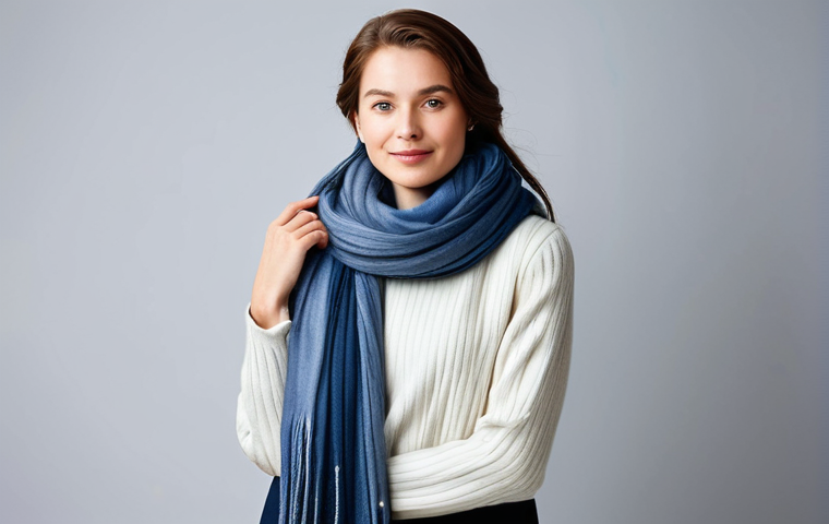A professional woman with elegant styling, fully clothed in a modest, contemporary winter outfit, standing in a well-lit, minimalist fashion studio. She is gracefully posing with various high-quality scarves in diverse colors – some cool-toned like muted blue and lavender, others warm-toned like rich camel and warm brown. The scarves are draped artistically around her neck and shoulders, showcasing their textures, including soft cashmere and luxurious wool. The focus is on the scarves as fashion accessories, complementing the overall professional aesthetic. Perfect anatomy, natural pose, correct proportions, well-formed hands, proper finger count. Professional fashion photography, studio lighting, high resolution, soft focus background, safe for work, appropriate content, modest, family-friendly.